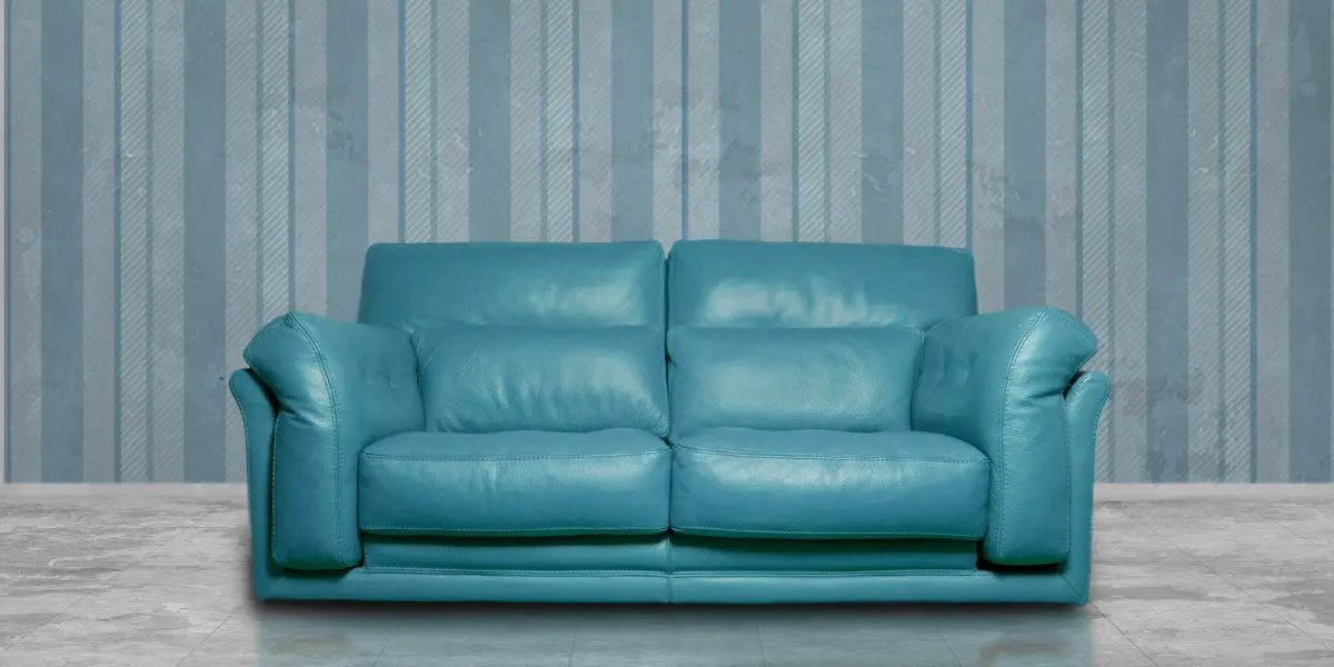 Sofa A modern turquoise leather sofa with sleek sofa upholstery from Sofa Repair Bahrain, set against a striped, textured backdrop. This design highlights premium leather upholstery and elegant sofa repair solutions, perfect for enhancing contemporary living spaces in Bahrain.