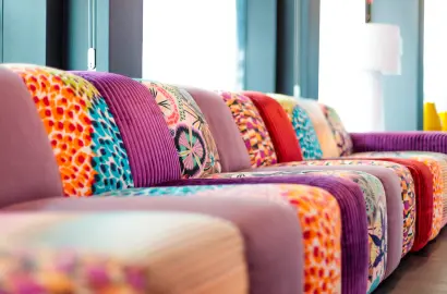 Sofa Repair Bahrain 7 A modern patchwork sofa featuring bold patterns and colorful sofa upholstery fabric, ideal for adding personality to living spaces. A perfect example of creative sofa upholstery for homes or offices in Bahrain. Experience innovative, multi-functional designs at Sofa Repair Bahrain.
