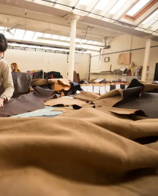 why-chose-us A craftsman working on premium leather upholstery in a well-equipped workshop. Highlights expertise in creating durable and elegant designs for sofas, chairs, and cushions in Bahrain.